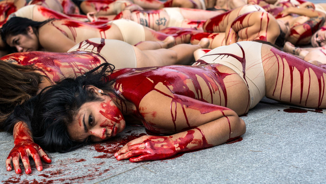 (Fotos): Activistas se desnudan y se cubren con sangre artificial en una zona comercial de España para protestar contra el uso de pieles